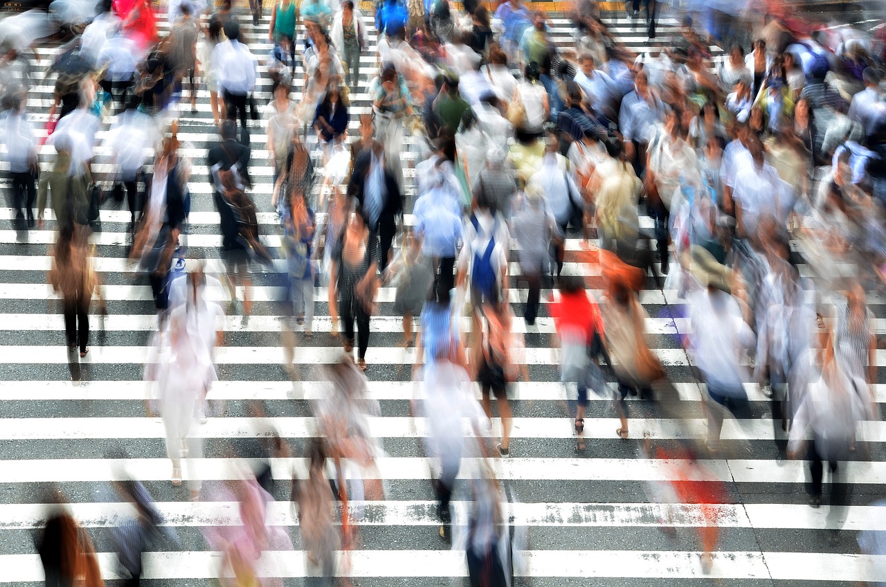 Photograph of a crowd of people in a large crosswalk