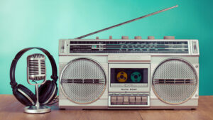 Photograph of a boom box, old-style microphone, and headphones