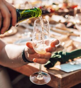 Photograph of someone pouring a glass of champagne.