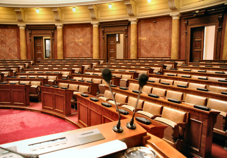 Image of a congressional hearing room in the center.