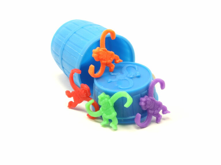 Image of the classic "barrel of monkeys" game featuring a blue cup with multi-colored plastic monkeys spilling out.