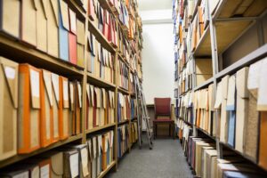 Photograph of stacks of archives.