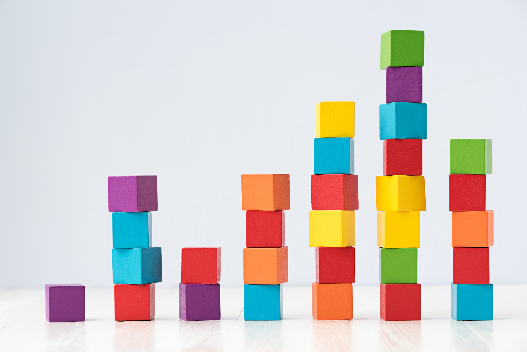 Photograph of seven stacks of colorful blocks of varying heights