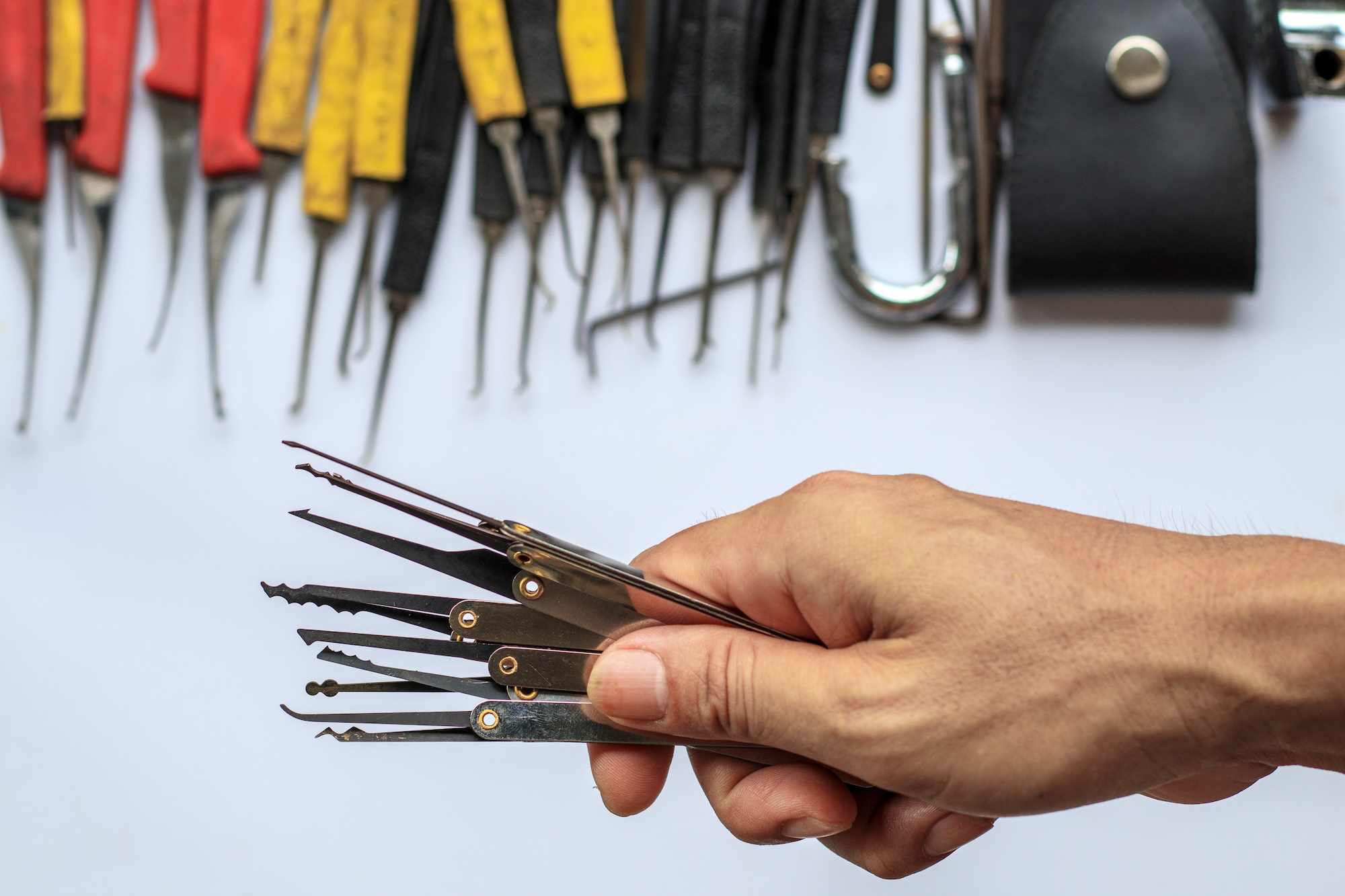 Photograph of a hand holding a selection of tools