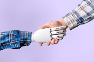 Image of a handshake with one robot hand, one human hand, against a lilac background.