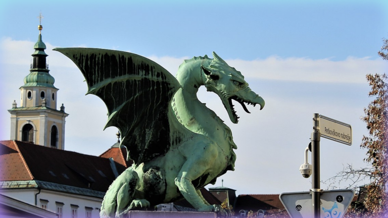 Image of a statue of a dragon on a bridge.