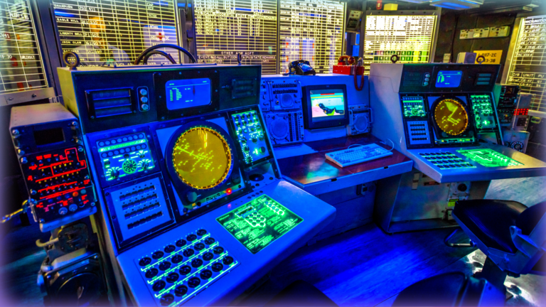 A combat information center radar console and maps of Battleship Midway at San Diego Navy Historic museum.