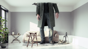 Image of the lower half of a very tall man who has broken through the ceiling of the room, with a broken sofa and tables at his feet.