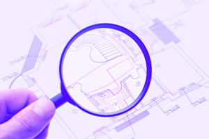 Image of a hand holding a magnifying glass over a blueprint done in shades of purple.