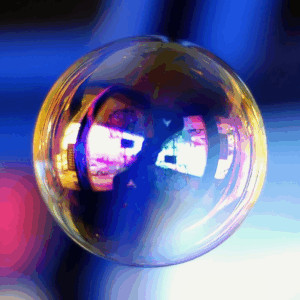 Image of a large bubble, reflecting shades of blue and pink.