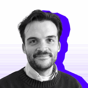 Image of Max in black and white, with a purple shadow behind him. Background white with thin purple lines.