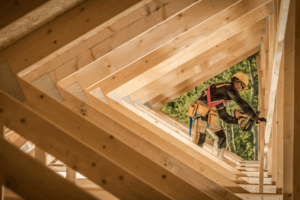 Image of a construction worker framed by a series of wooden triangles.