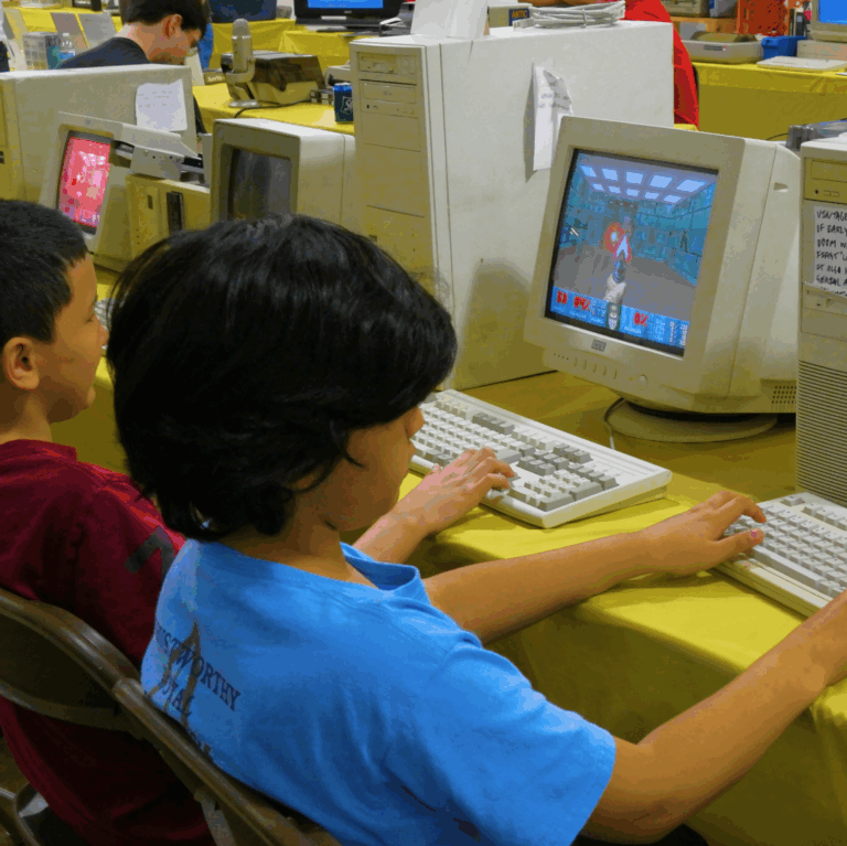 Photograph of children on 90s-style computers.