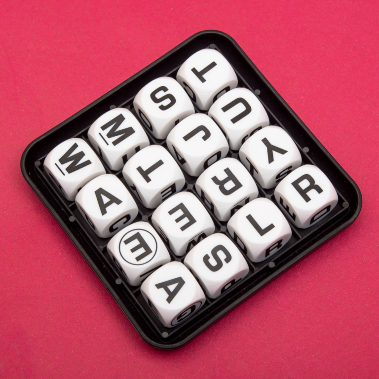 Image of a Boggle set against a dark pink background.