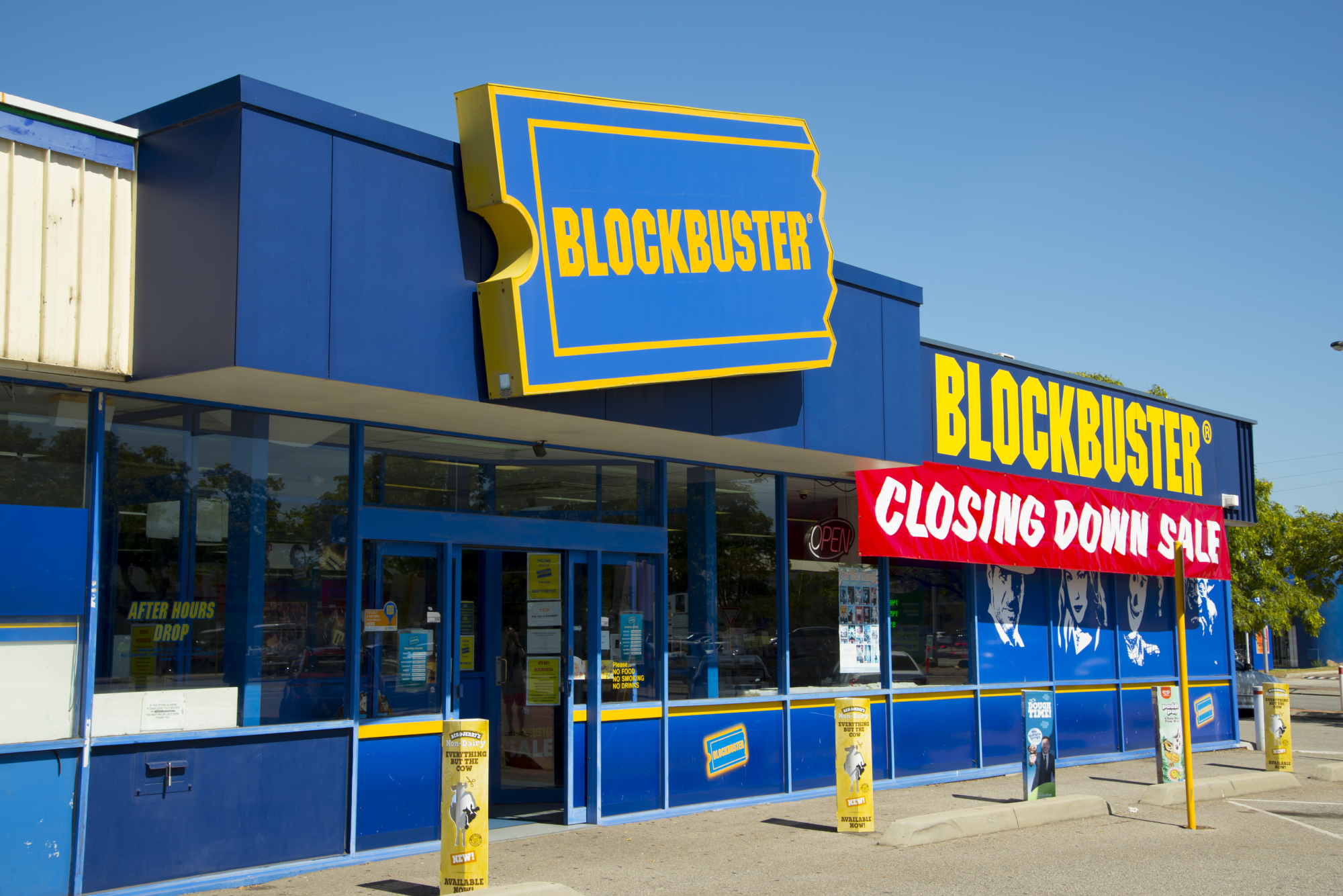 Image of a Blockbuster store with a big red "closing down sale" sign.