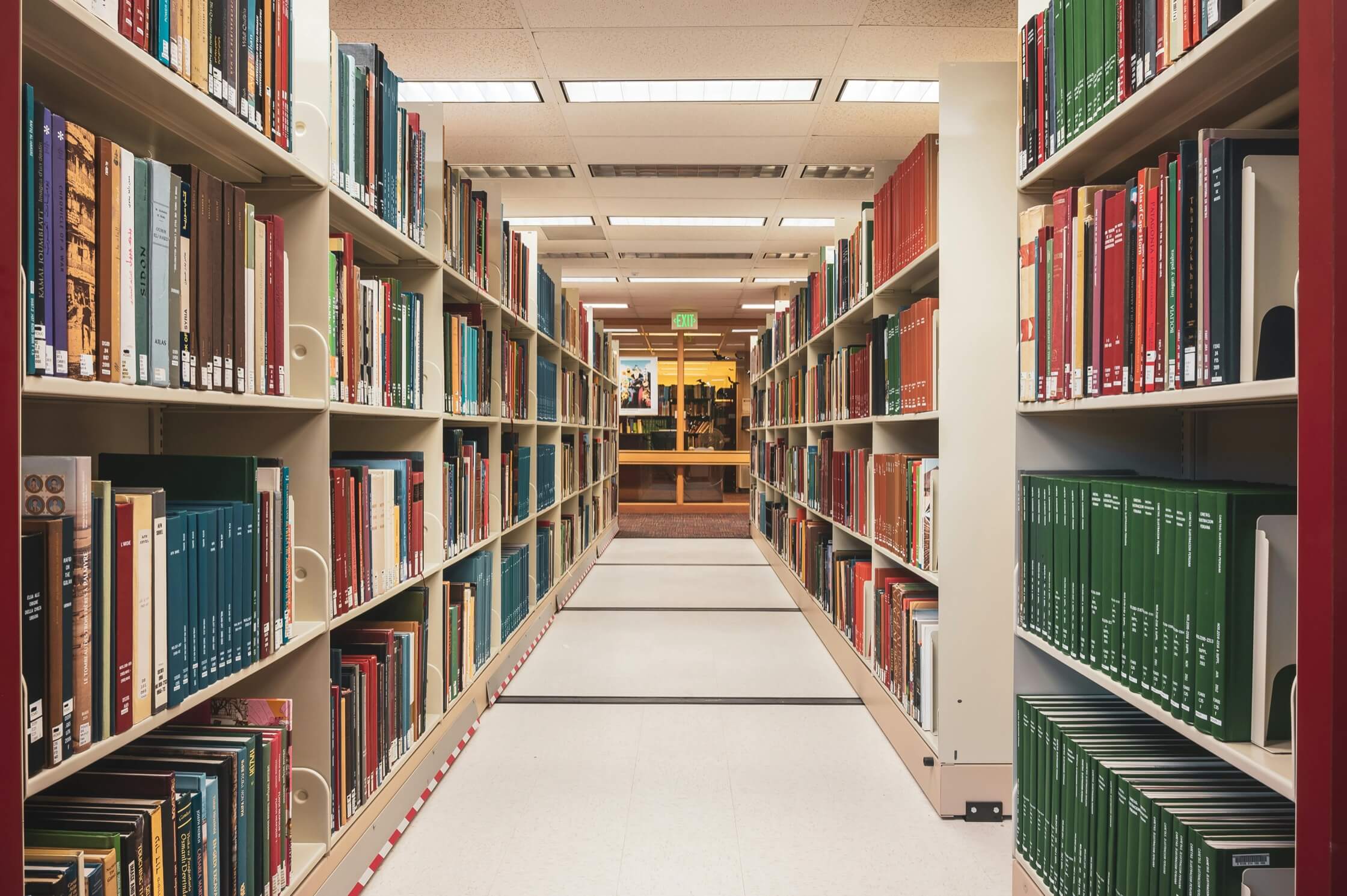 Library shelves lined with research volumes, representing Outsell's comprehensive B2B data and intelligence platform