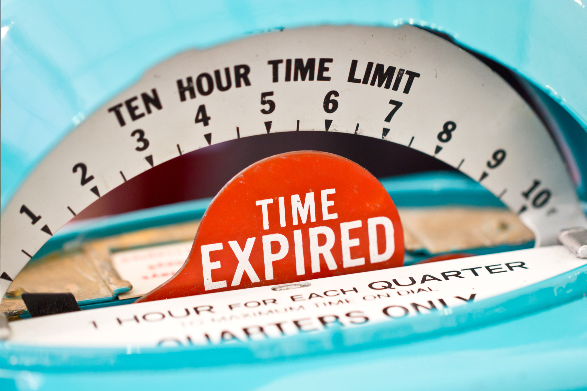 Image of an old-fashioned parking meter with a red "time expired" marker.