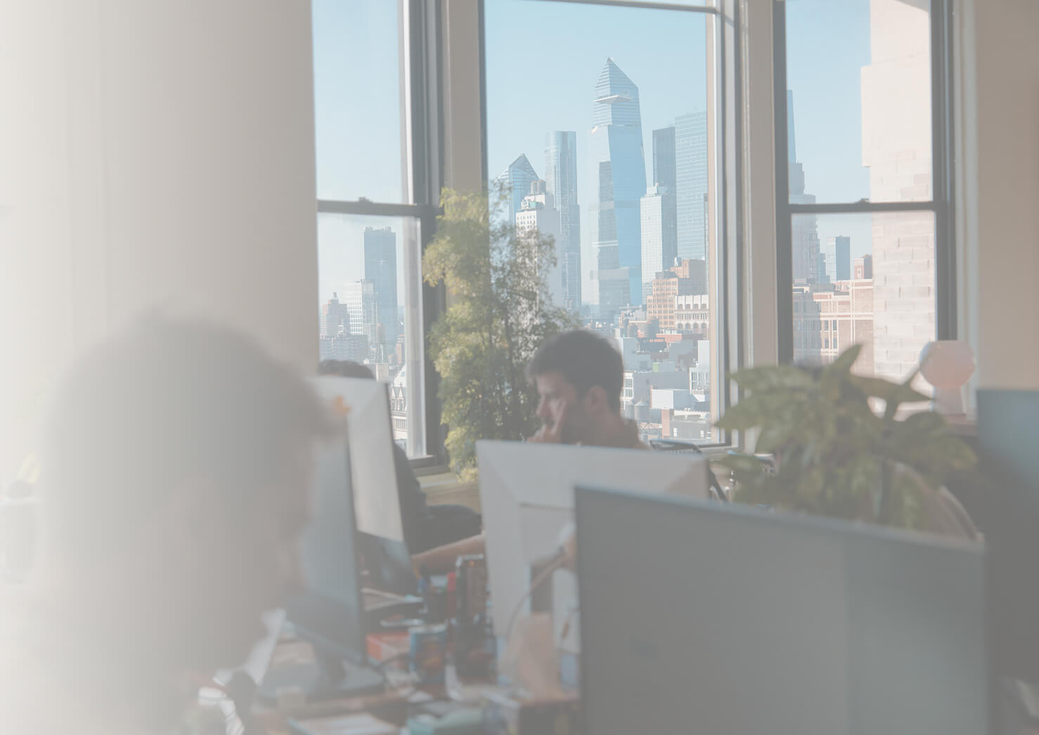 The Aboard studio in New York, with the Midtown skyline through the windows