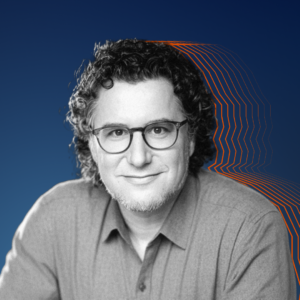 Black and white image of Eric with orange silhouette lines around his head, set against a navy background.