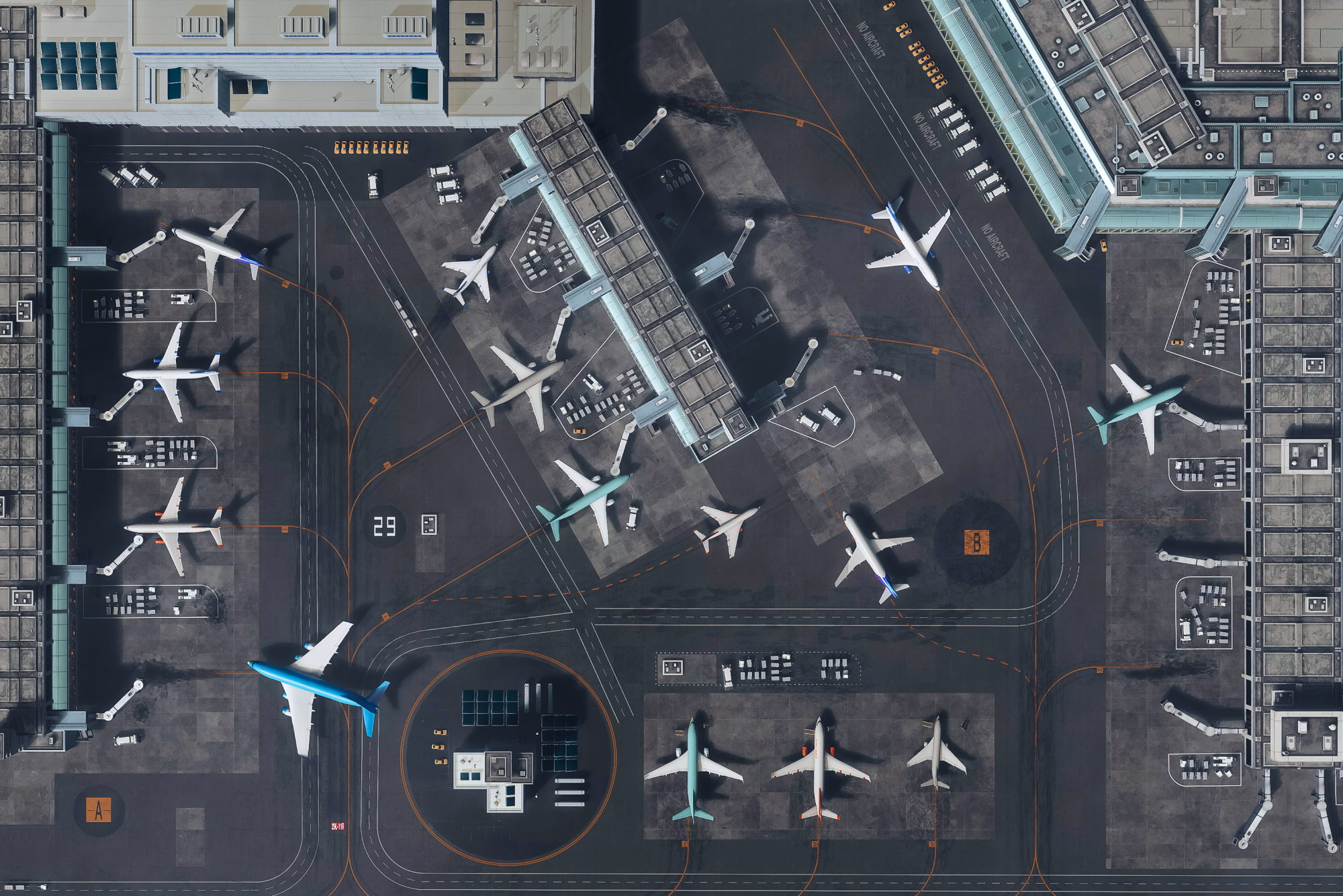 Aerial image of an airport tarmac featuring many planes.