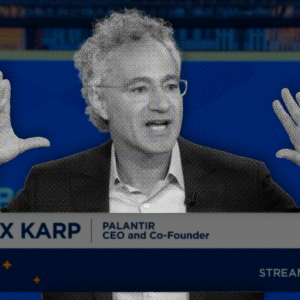 Image of Alex Karp on CNBC waving his hands in the air.
