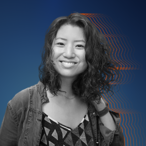Black and white image of Tricia against a dark blue background.