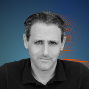 Black and white photo of Josh against a dark blue background with orange silhouette.
