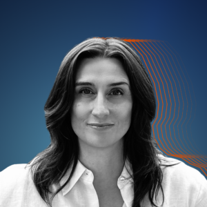 Black and white photo of Katie against a dark blue background, orange lines shadowed behind her head.