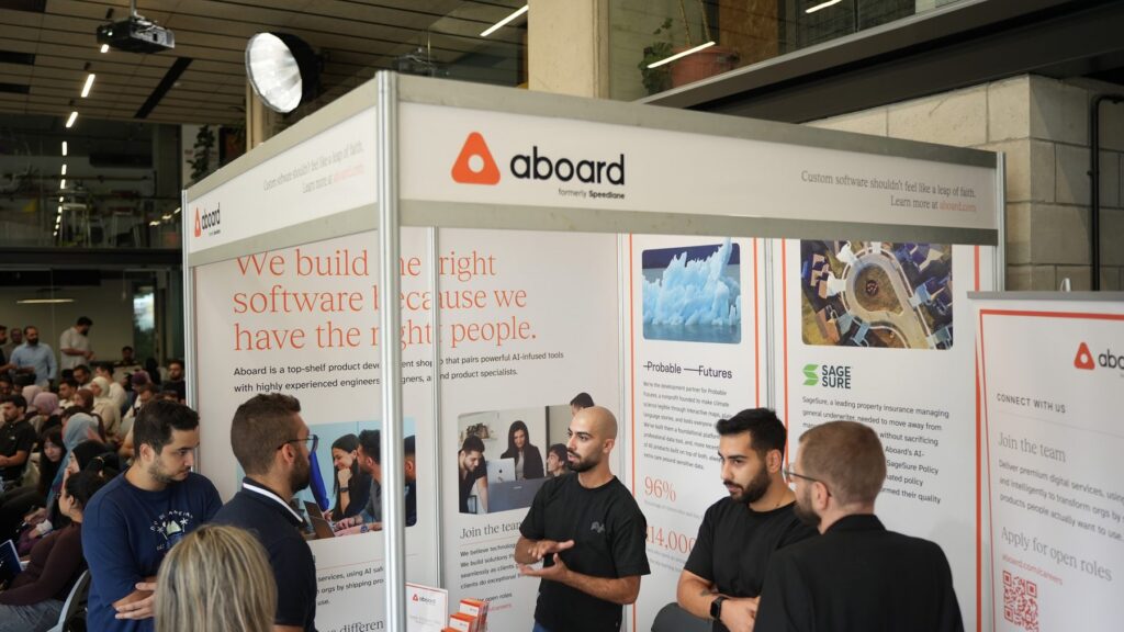 The Aboard booth at an event, with team members talking to visitors