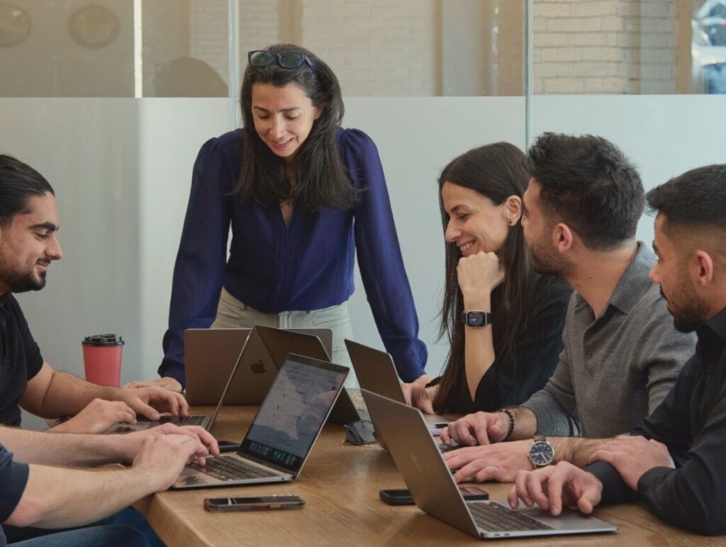 Six Aboard team members working through a project together around a meeting table